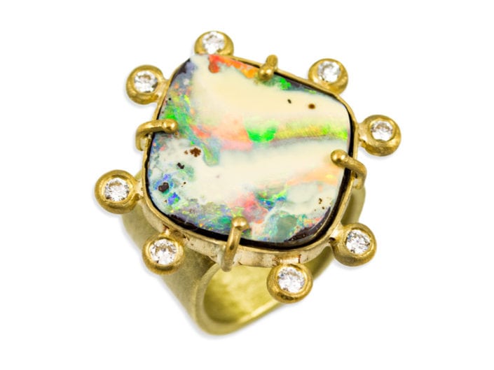 Large, beautiful boulder opal surrounded by 8 diamonds and set in 22k gold atop a 18k gold brushed band.
