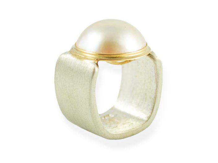 Mabe pearl in a 14k gold bezel setting atop a square, brushed sterling silver band.