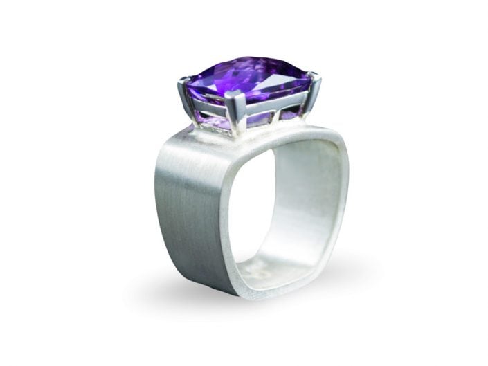 Stunning amethyst set in 14k white gold on a square, brushed sterling silver band.