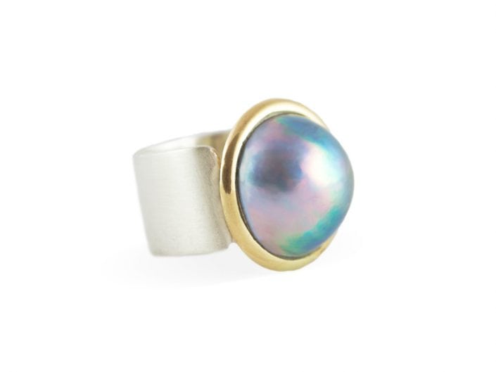 Tahitian pearl in a 14k gold bezel setting atop a square, brushed sterling silver band.
