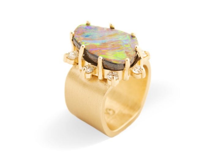 Large, beautiful boulder opal surrounded by 8 diamonds and set in 14k gold atop a 14k gold brushed band.
